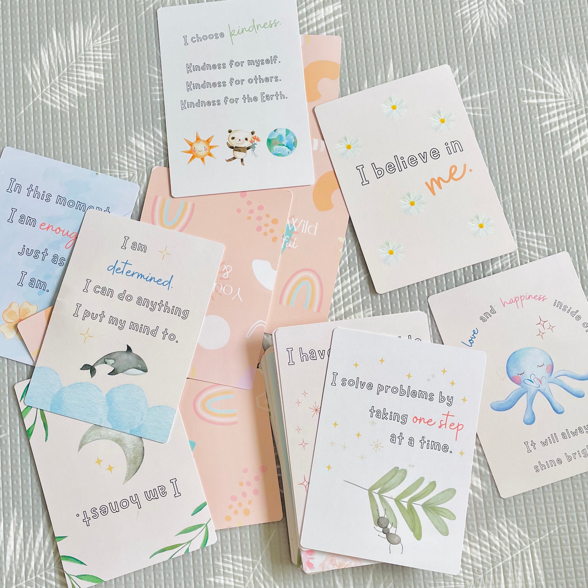 affirmation cards scattered on play mat